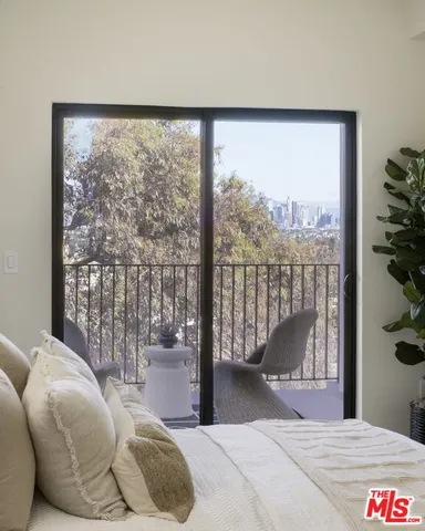 a bedroom with a large bed and a large window