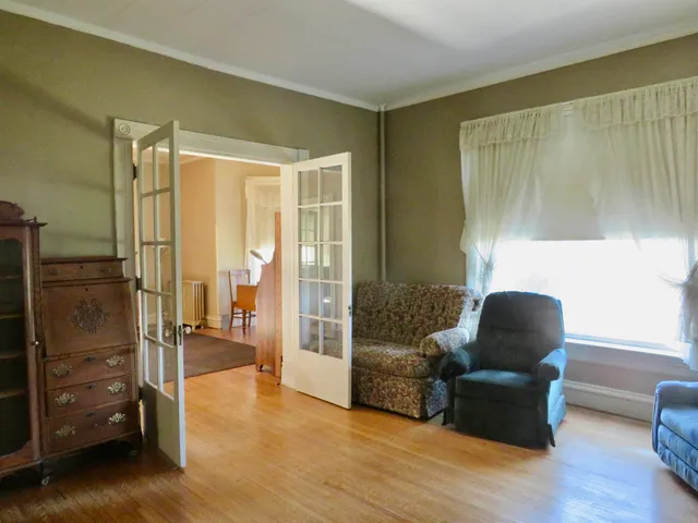 a living room with a fireplace and a wooden floor