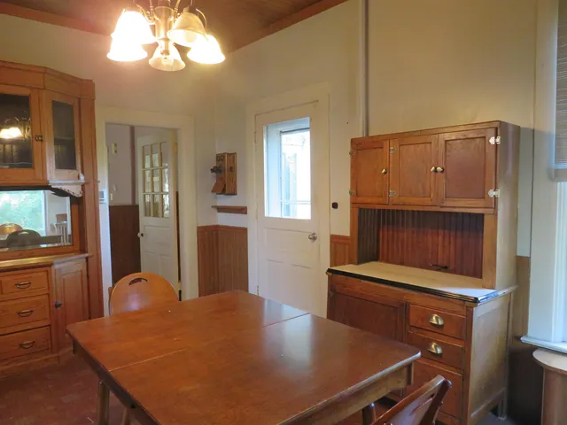 a kitchen with cabinets appliances and a window