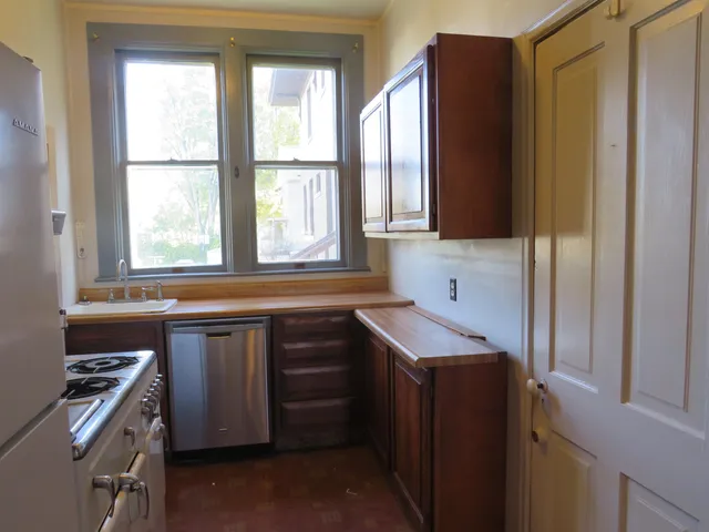 a living room with furniture a window and a chandelier