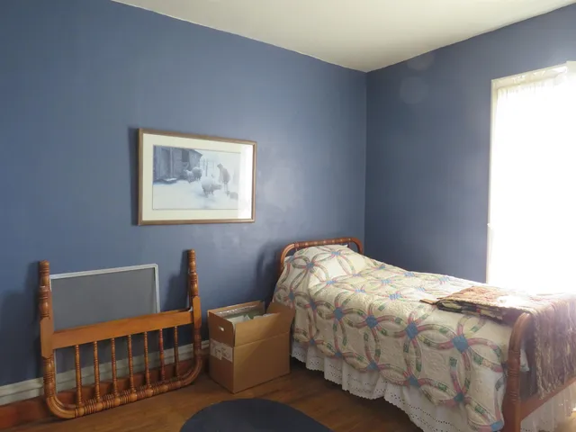 a bedroom with bed and window