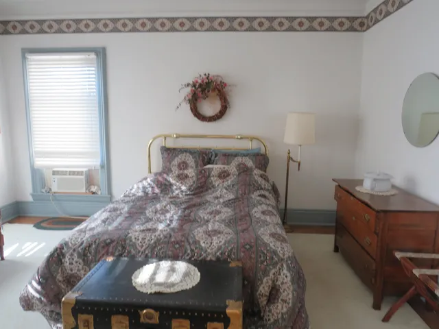 a living room with furniture and a dresser