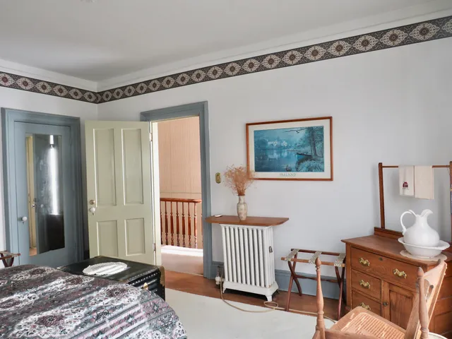 a bathroom with a granite countertop sink and a toilet