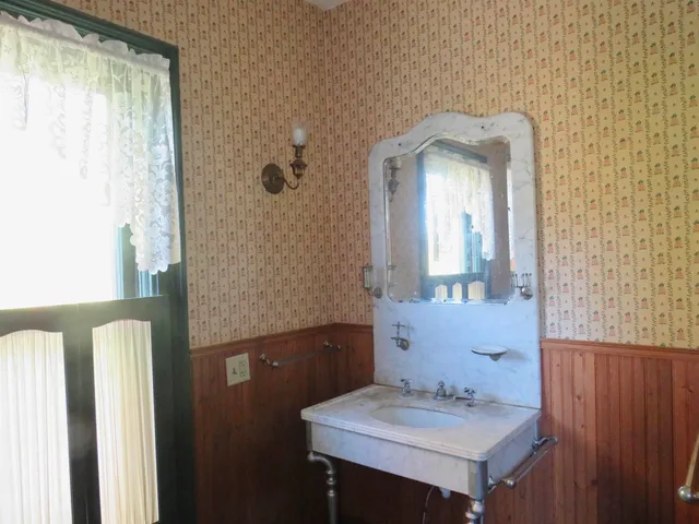 a view of a dining room with furniture and window