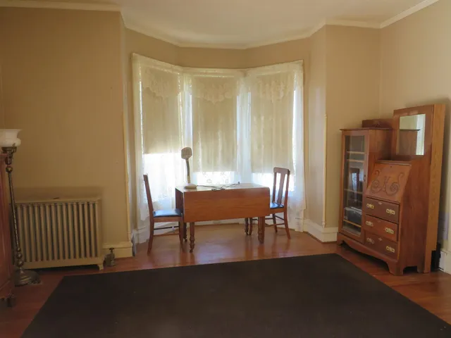 a view of a dining room with furniture and a window