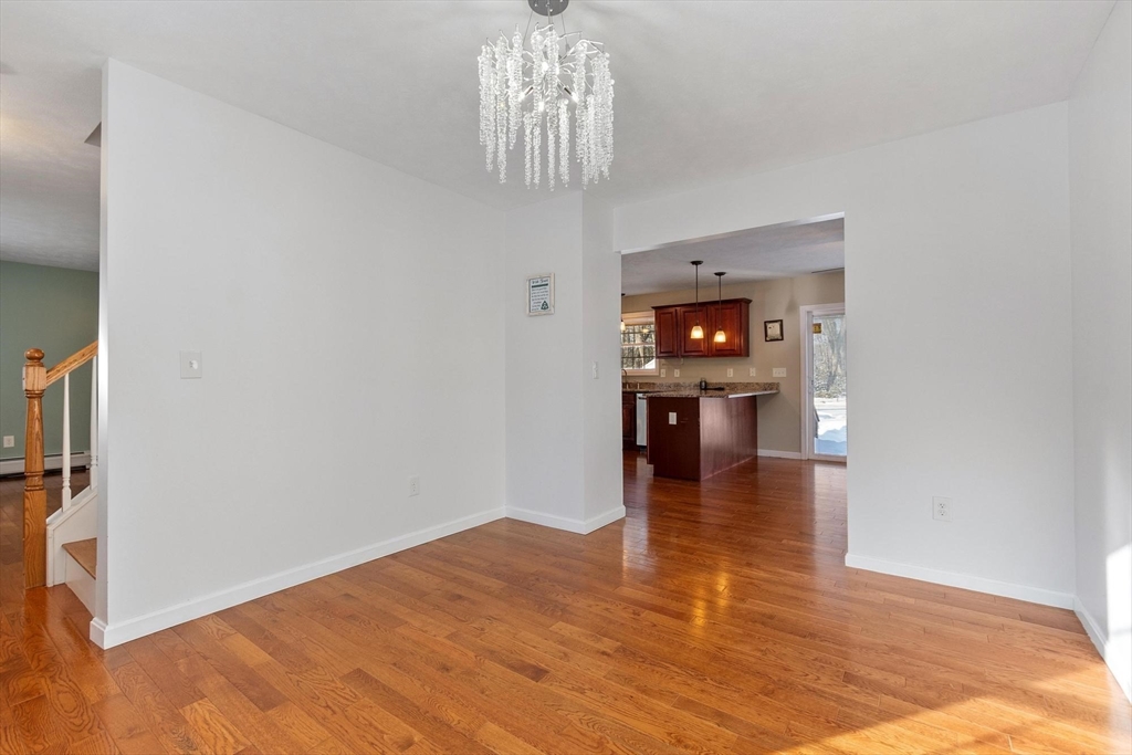 210 Bean Porridge Hill Road Westminster, MA 01473 - Photo 13 of 39 a view of a hallway view with wooden floor and a chandelier