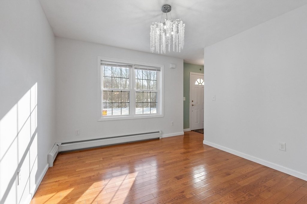 210 Bean Porridge Hill Road Westminster, MA 01473 - Photo 14 of 39 a view of an empty room with wooden floor and a window