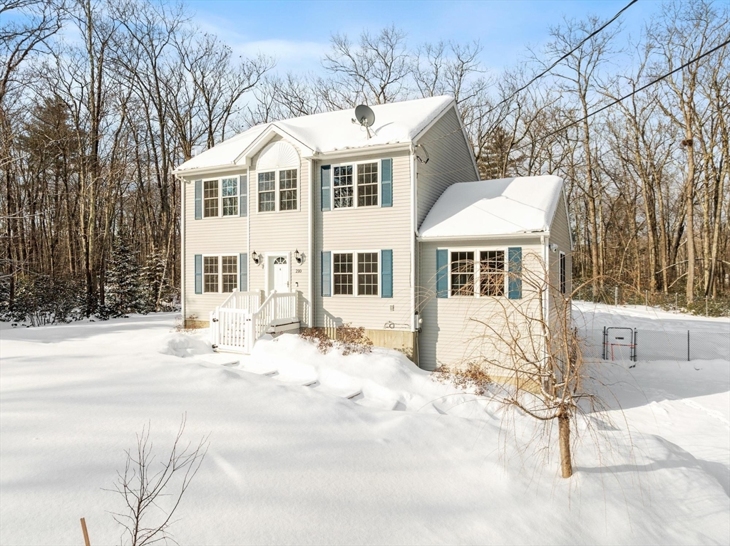 210 Bean Porridge Hill Road Westminster, MA 01473 - Photo 2 of 39 a front view of a house with a yard covered in snow