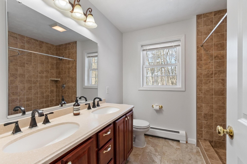 210 Bean Porridge Hill Road Westminster, MA 01473 - Photo 24 of 39 a bathroom with a double vanity sink and a mirror