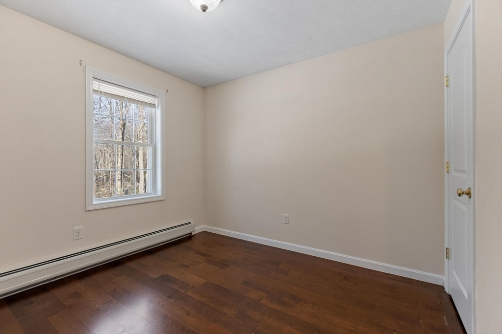 210 Bean Porridge Hill Road Westminster, MA 01473 - Photo 30 of 39 a view of an empty room with wooden floor and a window