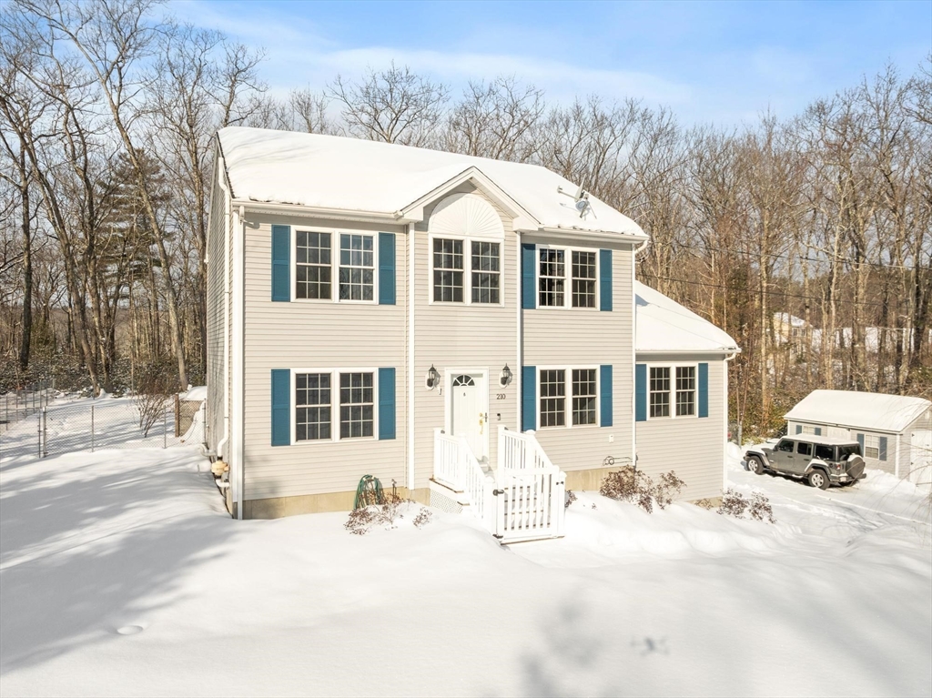 210 Bean Porridge Hill Road Westminster, MA 01473 - Photo 3 of 39 a front view of a house with a yard covered in snow