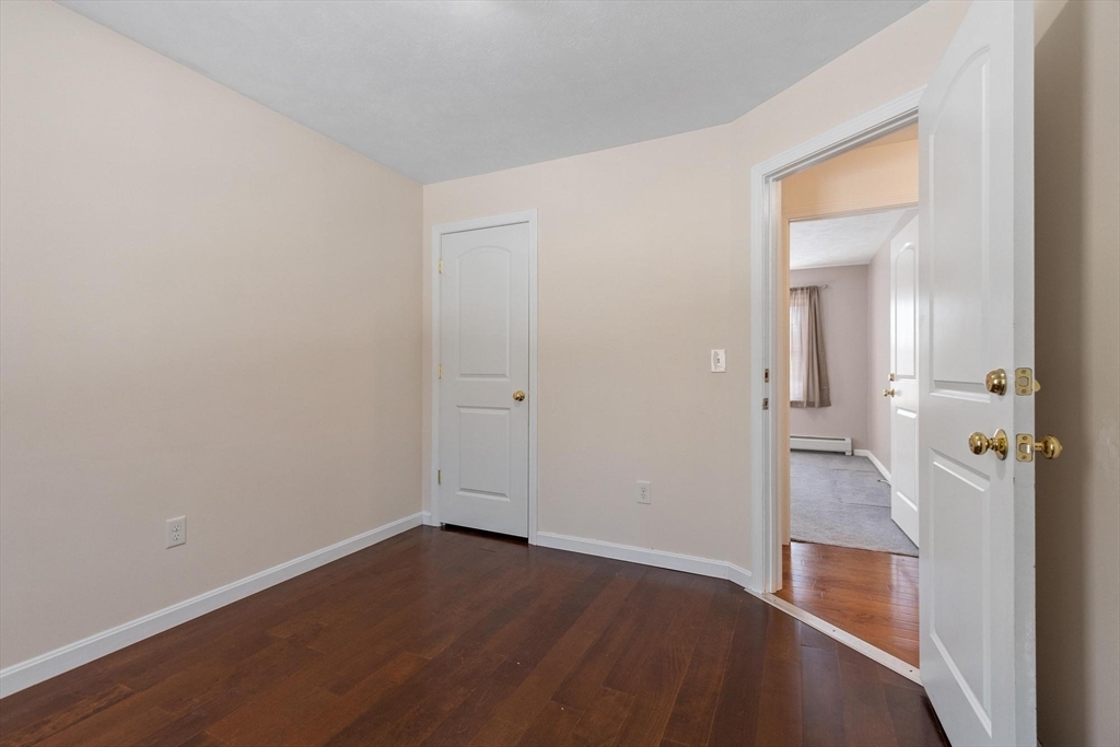 210 Bean Porridge Hill Road Westminster, MA 01473 - Photo 31 of 39 an empty room with wooden floor and a bathroom