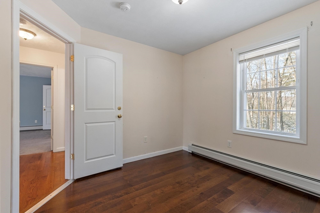 210 Bean Porridge Hill Road Westminster, MA 01473 - Photo 32 of 39 an empty room with wooden floor and windows