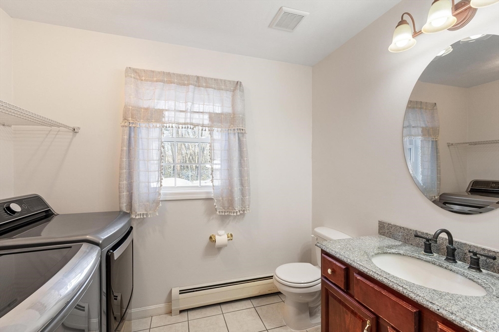 210 Bean Porridge Hill Road Westminster, MA 01473 - Photo 34 of 39 a bathroom with a granite countertop toilet sink and mirror