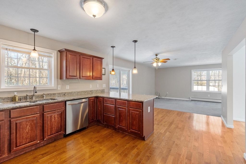 210 Bean Porridge Hill Road Westminster, MA 01473 - Photo 8 of 39 a large kitchen with kitchen island granite countertop wooden floors granite counter tops and a sink