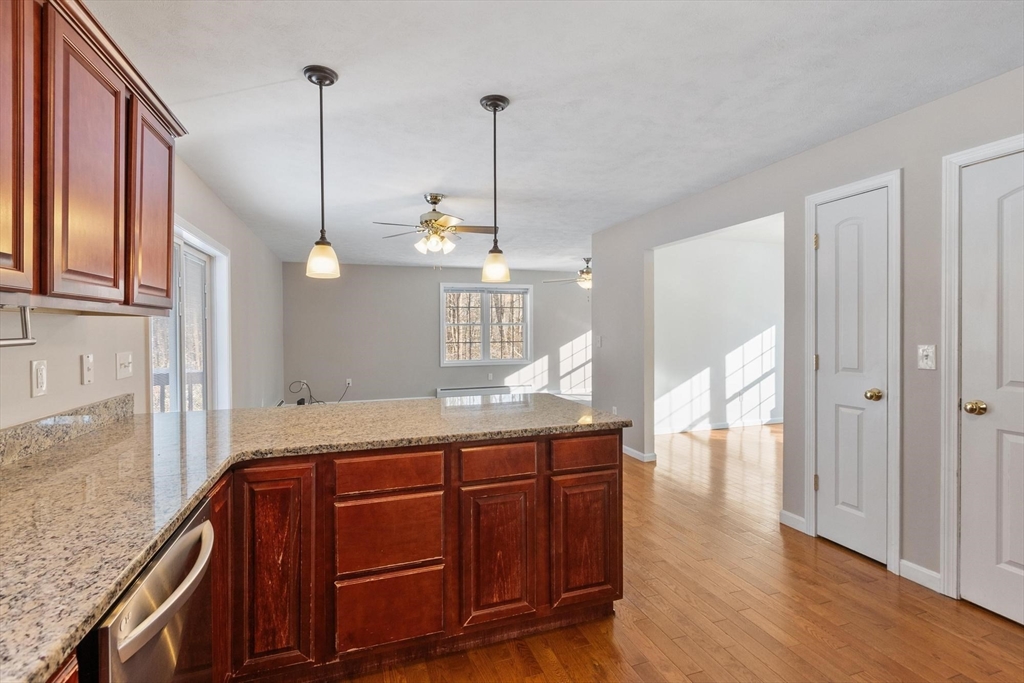 210 Bean Porridge Hill Road Westminster, MA 01473 - Photo 10 of 39 a kitchen with granite countertop cabinets and wooden floor