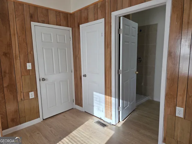 a view of a hallway with wooden floor