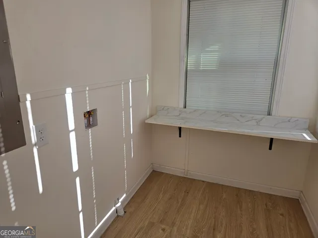 a view of a hallway with wooden floor
