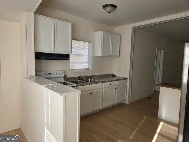 a kitchen with a stove and a refrigerator