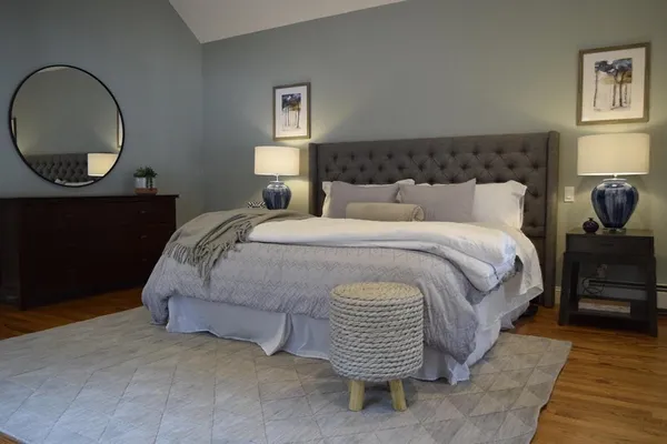 a spacious bedroom with a bed and a window