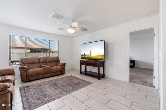 a living room with furniture a rug and a flat screen tv