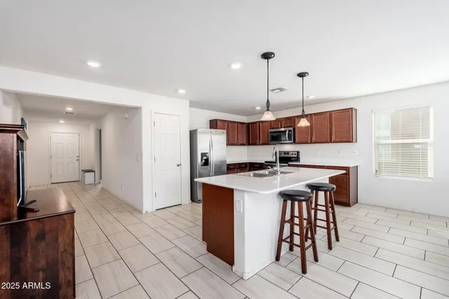 a open kitchen with stainless steel appliances kitchen island granite countertop a sink and a stove