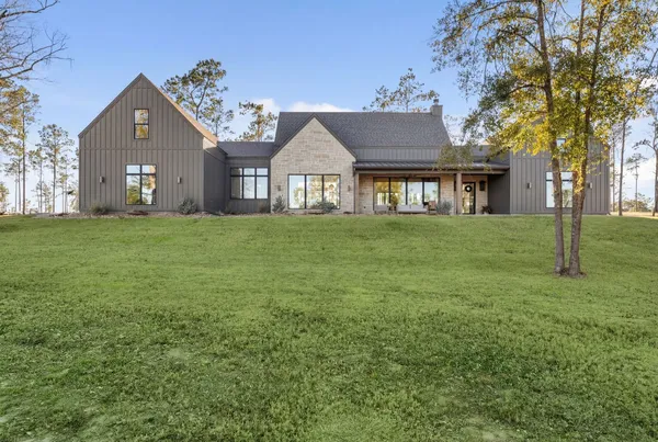 a large house with a big yard and large trees