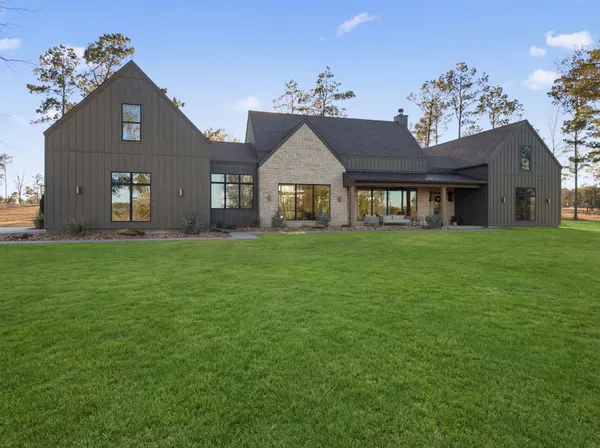 a front view of house with yard and green space