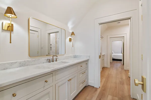 a spacious bathroom with a granite countertop sink mirror and vanity