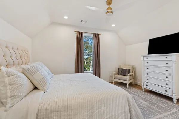 a bedroom with a bed and a television