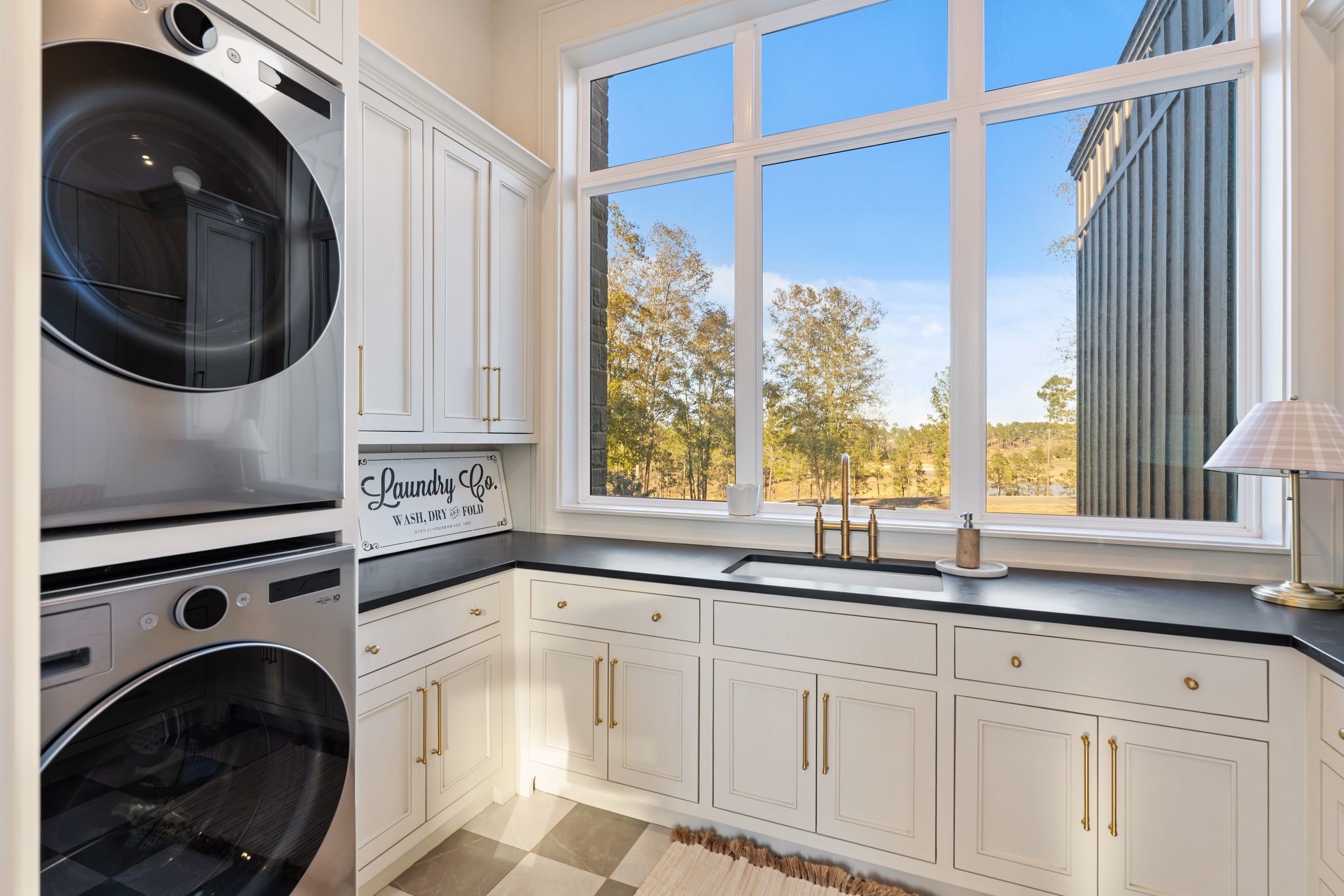 308 Western Road Livingston, TX 77351 - Photo 41 of 49 a kitchen with a sink a washer and dryer next to a window