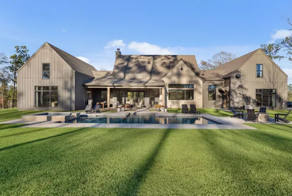 a view of a house with swimming pool and sitting area