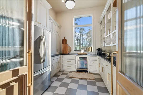 a kitchen with stainless steel appliances a refrigerator sink and microwave