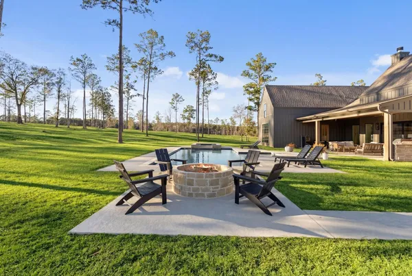 a view of a house with a swimming pool and a patio