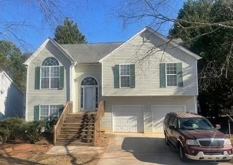 a front view of a house with parking space