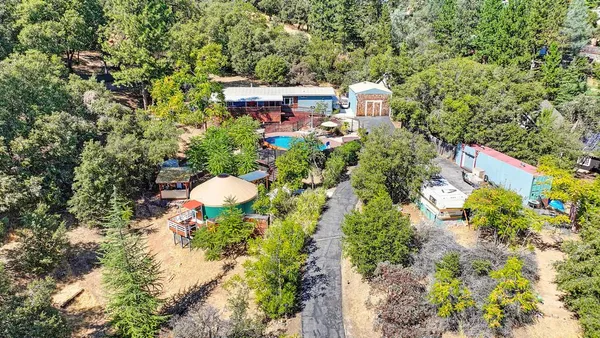an aerial view of a house with a yard and garden