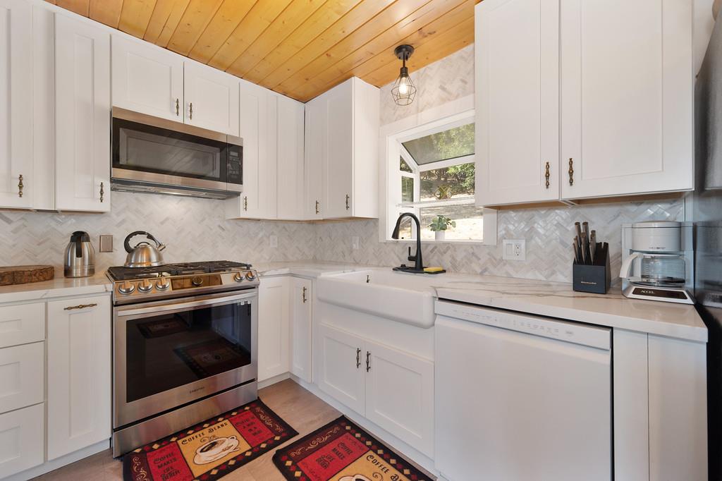 333 Pine Street Colfax, CA 95713 - Photo 11 of 65 a kitchen with stainless steel appliances granite countertop a sink stove a microwave and cabinets