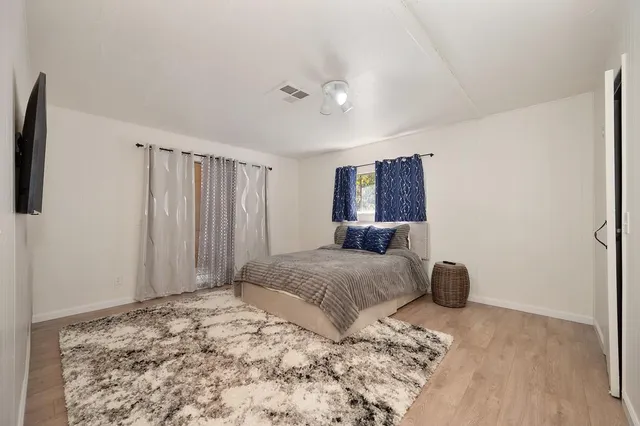 a bedroom with a bed and lamp