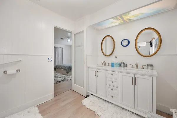 a view of a walk in closet and bathroom