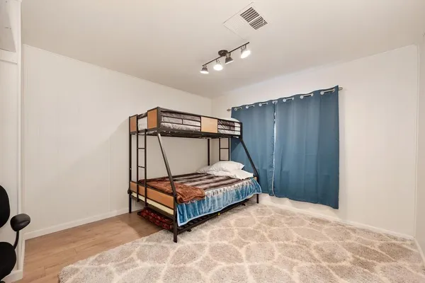 a bedroom with a bed and window