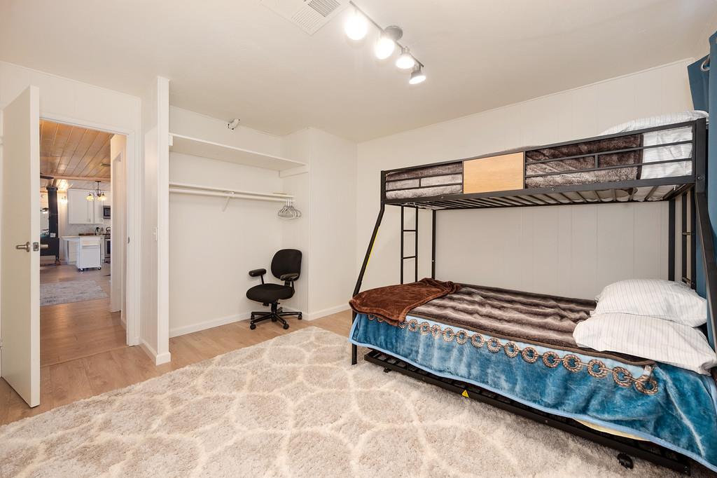 333 Pine Street Colfax, CA 95713 - Photo 21 of 65 a bedroom with a bed and wooden floor