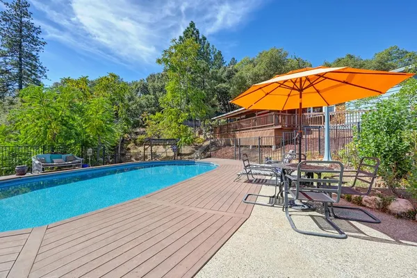 a roof deck with chairs and wooden floor