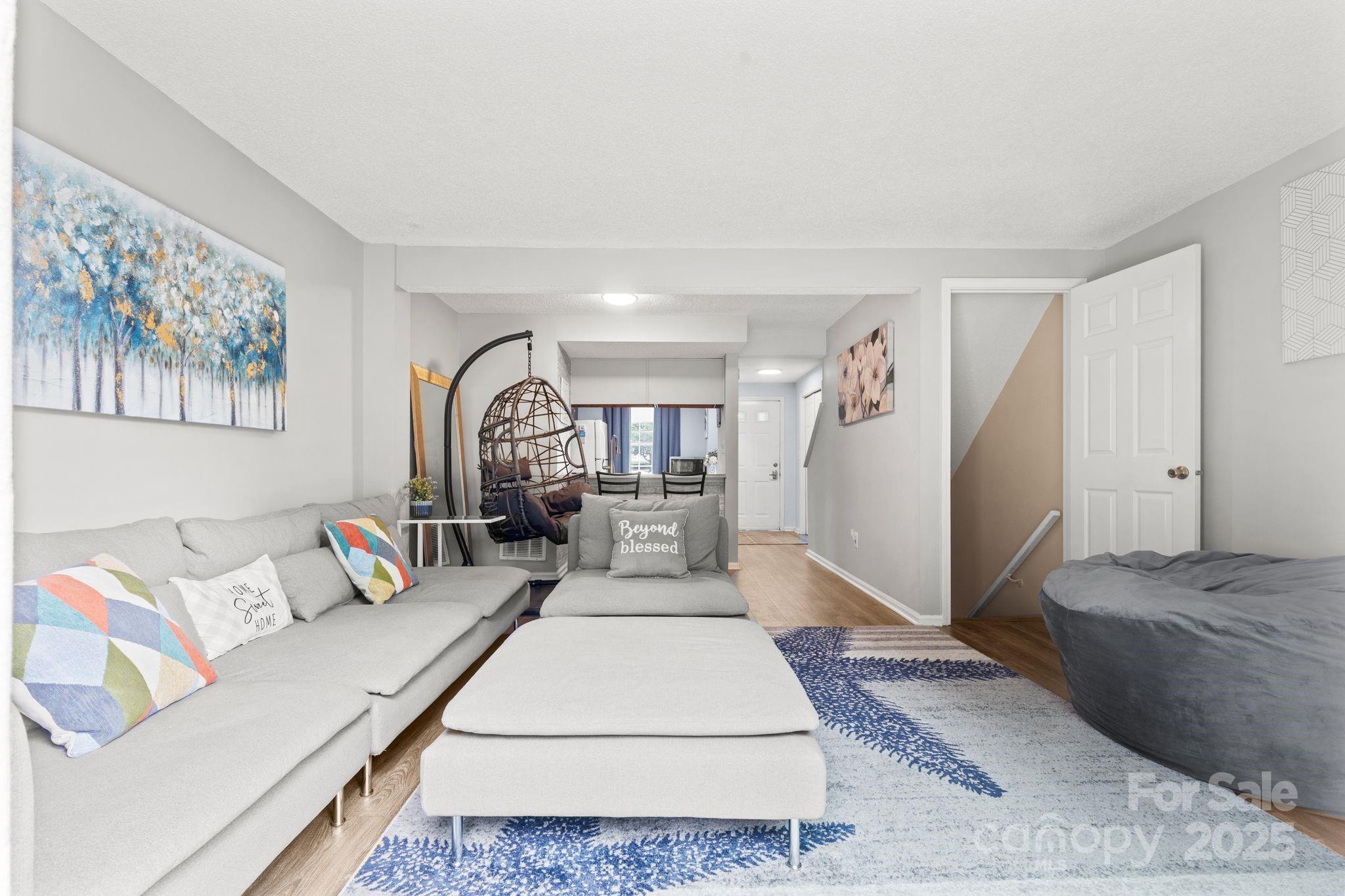 9606 Vinca Circle, Unit E Charlotte, NC 28213 - Photo 13 of 26 a living room with furniture and a rug