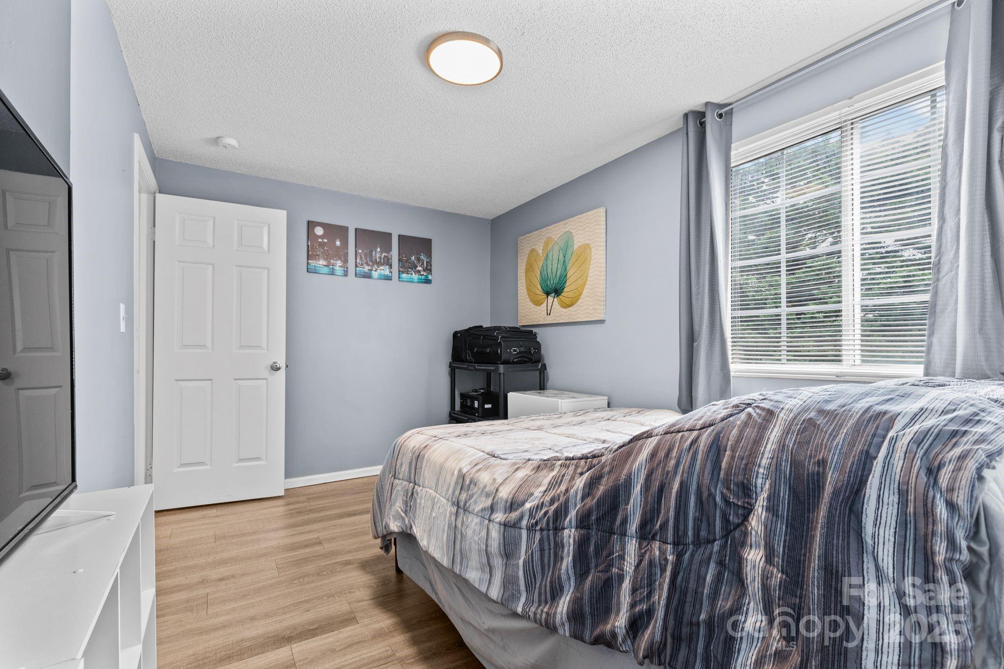 9606 Vinca Circle, Unit E Charlotte, NC 28213 - Photo 16 of 26 a bedroom with a bed and a window