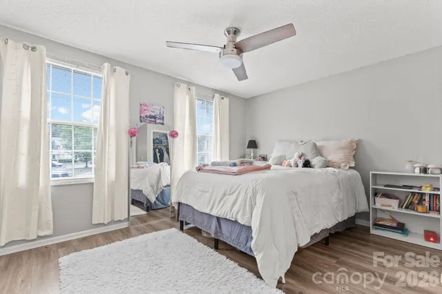 a bedroom with a bed closet and flat screen tv