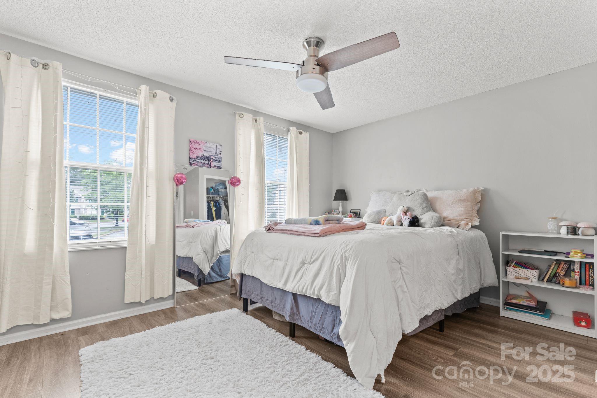 9606 Vinca Circle, Unit E Charlotte, NC 28213 - Photo 18 of 26 a bedroom with bed and window