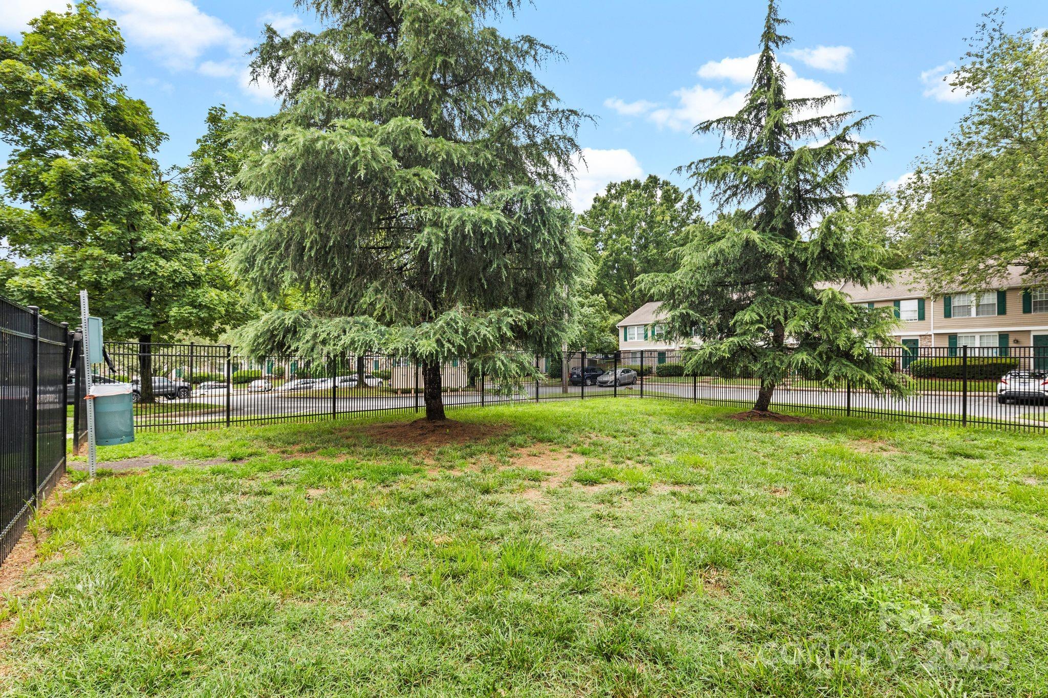 9606 Vinca Circle, Unit E Charlotte, NC 28213 - Photo 24 of 26 a view of a park with a tree