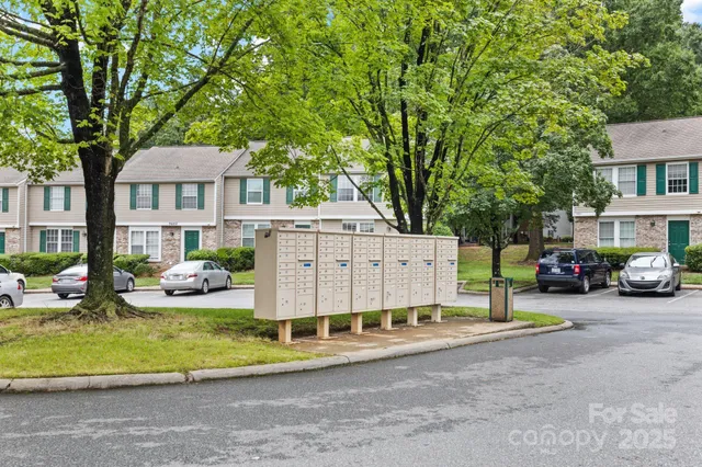 a view of a house with a patio and a yard
