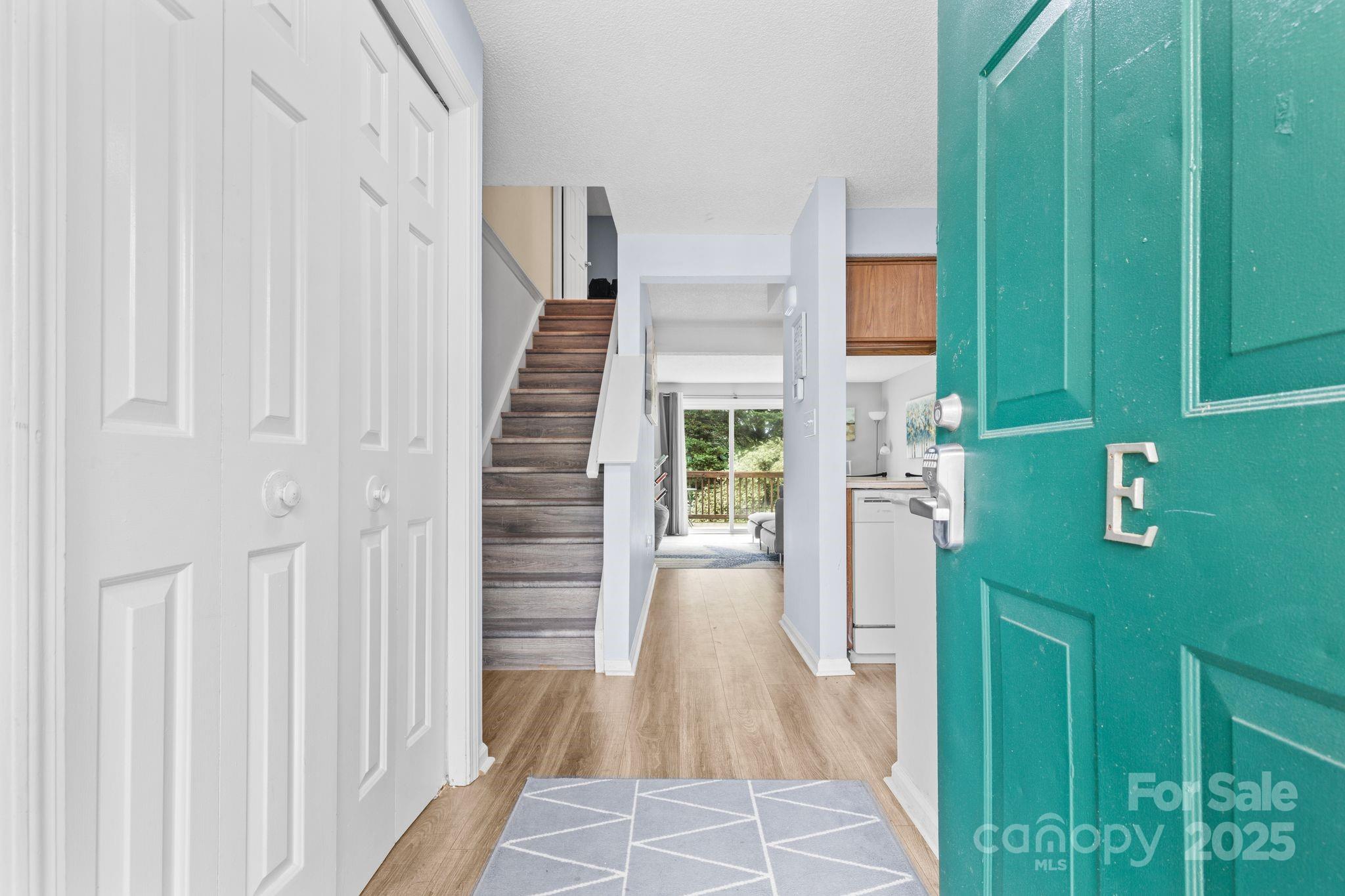 9606 Vinca Circle, Unit E Charlotte, NC 28213 - Photo 5 of 26 a view of a hallway with wooden floor and entryway
