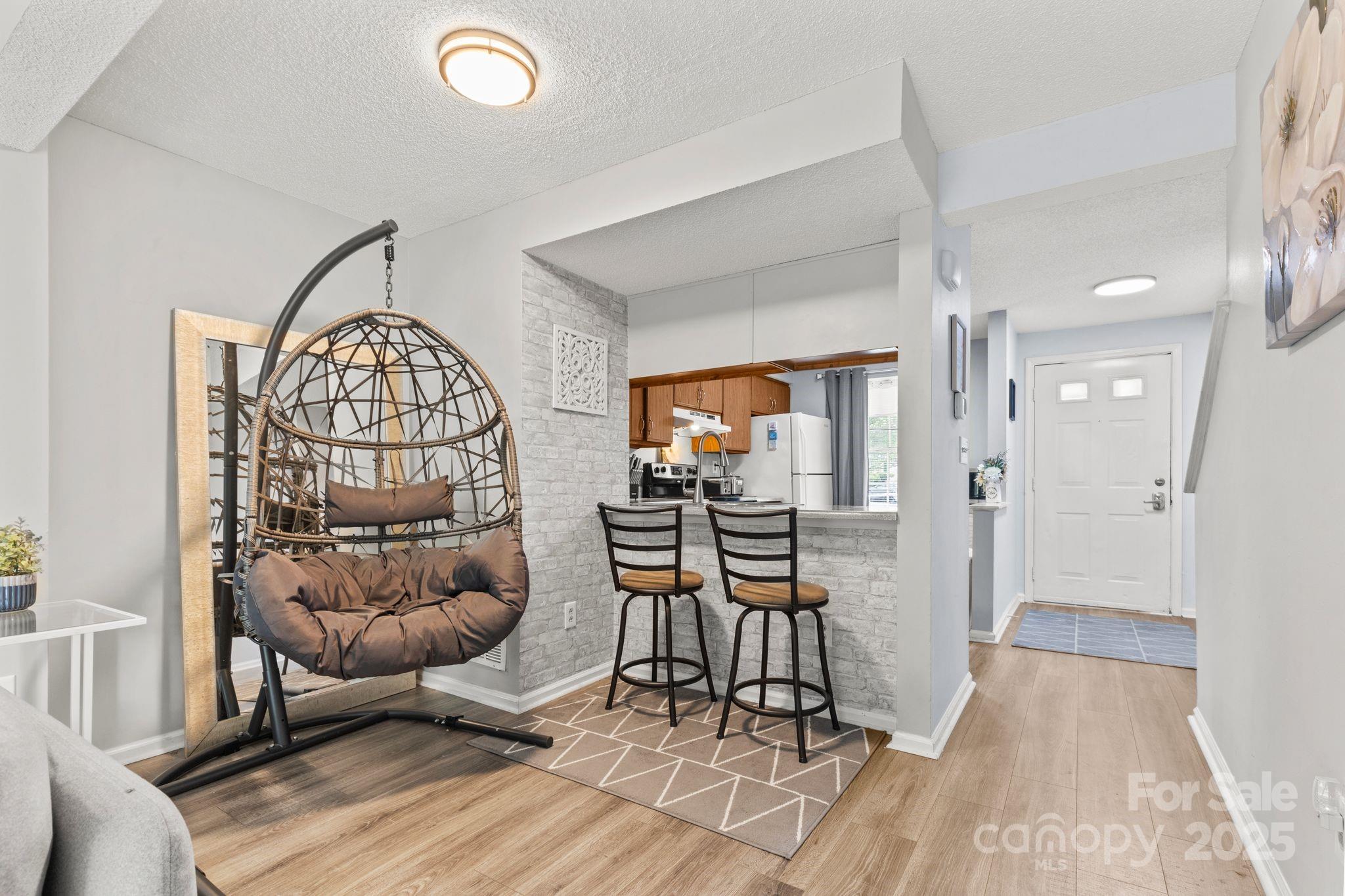9606 Vinca Circle, Unit E Charlotte, NC 28213 - Photo 9 of 26 a view of a livingroom with furniture and wooden floor